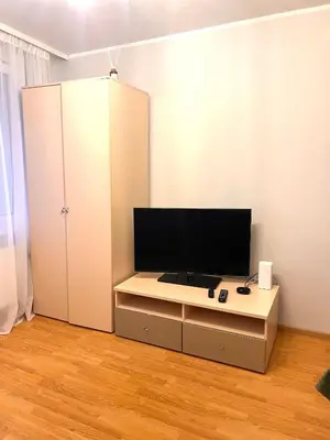a living room with a tv and a white cabinet at Butas Trakuose su vaizdu į ežerus-Lake view apartment in Trakai in Trakai