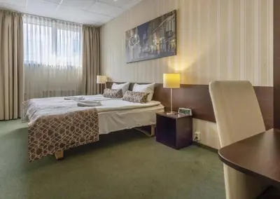 a hotel room with a bed and a table at Naujamiescio Studio in Vilnius