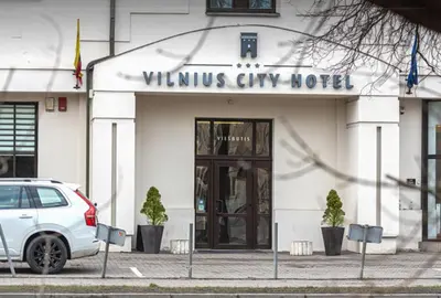 a white car parked in front of a building at Naujamiescio Studio in Vilnius