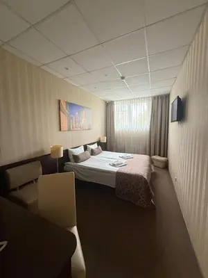 a hotel room with a bed and a couch at Naujamiescio Studio in Vilnius