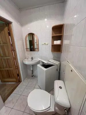 a bathroom with a toilet and a sink at Cozy Maumedziu apartment in Vilnius