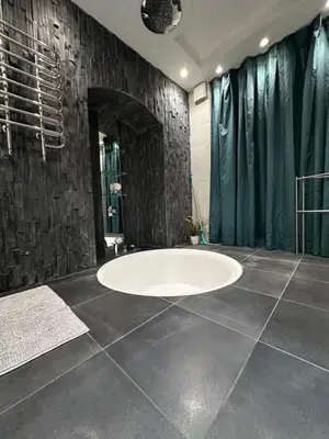 a bathroom with a large white tub in a room at B&M Romantic room Self check-in in Vilnius