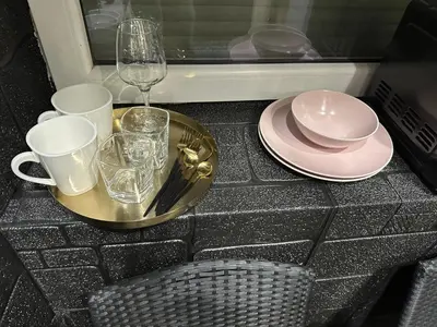 a table with a tray with plates and glasses and a glass at B&M Romantic room Self check-in in Vilnius