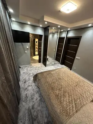 a master bedroom with a bed and a walk in closet at B&M Romantic room Self check-in in Vilnius