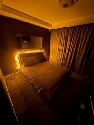 a bedroom with a bed with lights on it at B&M Romantic room Self check-in in Vilnius