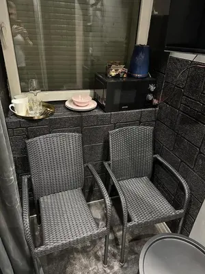 two chairs and a table with a plate on a counter at B&M Romantic room Self check-in in Vilnius