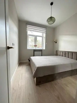 a bedroom with a bed and a window at Cozy City Center Apartment in Kaunas
