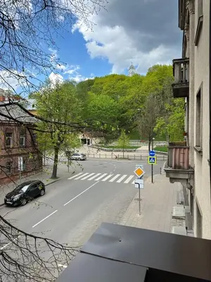 a view of a street with a car on the road at Cozy City Center Apartment in Kaunas