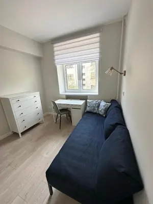 a bedroom with a bed and a desk in it at Cozy City Center Apartment in Kaunas