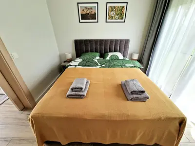 a bedroom with a bed with two towels on it at Rasota Pieva Dewy Meadow