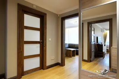 a room with a sliding door and a living room at Luxury apartment Vytauto 16 in Druskininkai