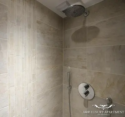 a bathroom with a shower with a glass door at Luxury apartment Vytauto 16 in Druskininkai
