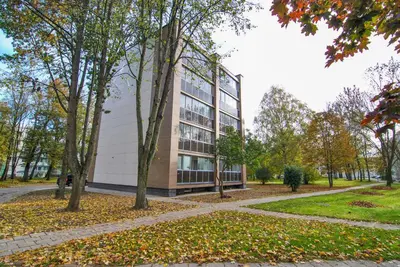 a tall building with trees in front of it at Luxury apartment Vytauto 16 in Druskininkai