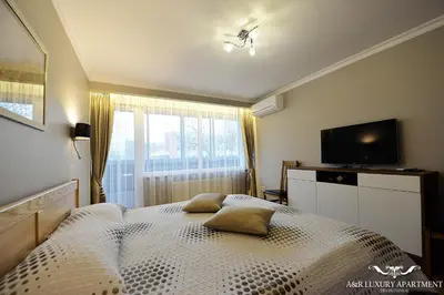 a bedroom with a bed with two pillows on it at Luxury apartment Vytauto 16 in Druskininkai