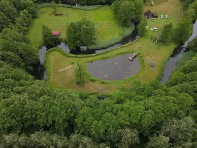 an aerial view of a park with a pond at Sodyba LAIMĖS SLĖNIS in Kapčiamiestis