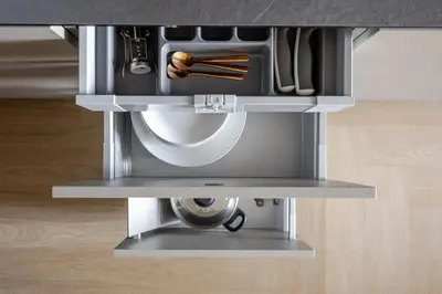 a kitchen under a counter with a metal drawer at Luxury Honey Moon Apartments with Free Underground Parking in Kaunas
