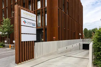 a building with a sign on the side of it at Luxury Honey Moon Apartments with Free Underground Parking in Kaunas