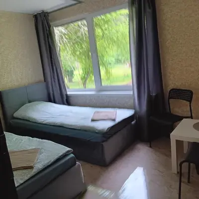 a room with a bed and a window and a couch at Valva vila in Luokesos Sen