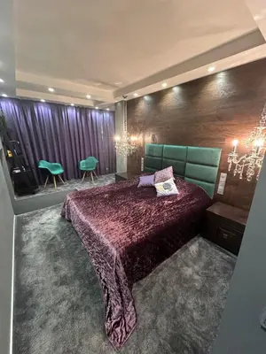 a bedroom with a large bed and green chairs at B&M Mini jecuzzi Lovers room Self check-in in Vilnius