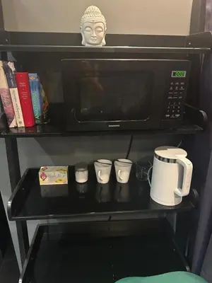 a black table with cups and a microwave at B&M Mini jecuzzi Lovers room Self check-in in Vilnius