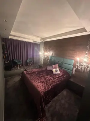 a bedroom with a bed and a chandelier at B&M Mini jecuzzi Lovers room Self check-in in Vilnius