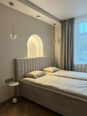 a bedroom with a large bed with a large window at Apartamentai pirmame aukšte, miesto centre in Vilkaviškis