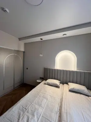 a bedroom with a large bed with two pillows at Apartamentai pirmame aukšte, miesto centre in Vilkaviškis