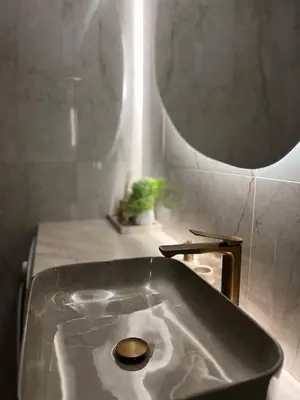 a large sink in a bathroom with a mirror at Apartamentai pirmame aukšte, miesto centre in Vilkaviškis