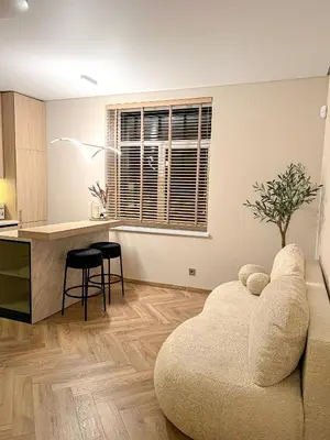 a living room with a couch and a table at Apartamentai pirmame aukšte, miesto centre in Vilkaviškis