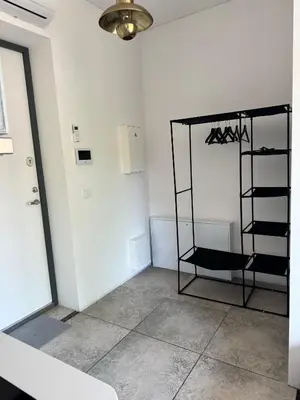 a room with a mirror and a shelf on the wall at Cozy Apartment in Vilnius Paupys in Vilnius