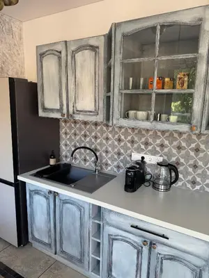 a kitchen with a sink and a refrigerator at Cozy Apartment in Vilnius Paupys in Vilnius