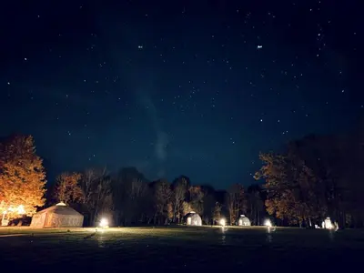 a field at night with a group of domes at Intimate Peaceful Yurt Surrounded by Nature in Lithuania in Jundeliškės
