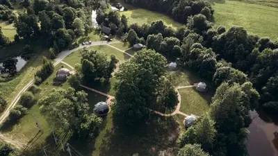 an overhead view of a park with trees and tents at Intimate Peaceful Yurt Surrounded by Nature in Lithuania in Jundeliškės