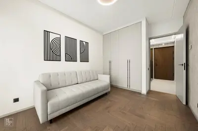 a white living room with a couch and a mirror at Comfortable 2 BD Apartment by Domvia in Kaunas