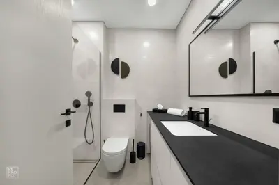 a white bathroom with a toilet and a sink at Comfortable 2 BD Apartment by Domvia in Kaunas