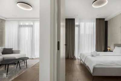 a white bedroom with a bed and a couch at Comfortable 2 BD Apartment by Domvia in Kaunas