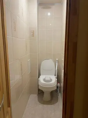 a small bathroom with a toilet and a shower at Butas prie tvenkinio in Varėna