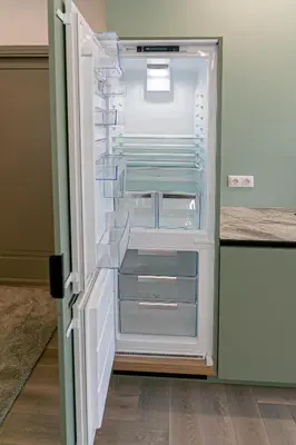 an empty refrigerator with its door open in a kitchen at River View Apartment with free parking in Kaunas