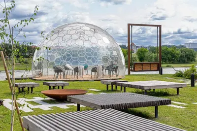 a dome with a group of chairs in a park at River View Apartment with free parking in Kaunas