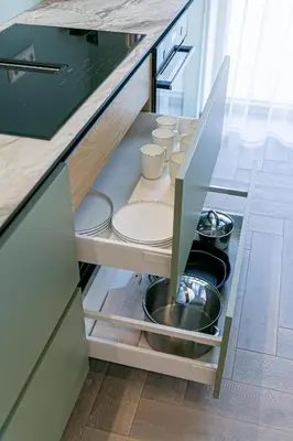 a kitchen drawer with plates and pans in it at River View Apartment with free parking in Kaunas