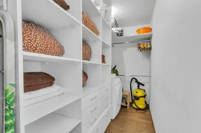 a white kitchen with white shelves at Vilnius Old Town Amber Penthouse in Vilnius
