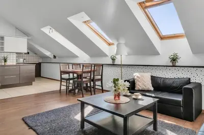 a living room with a couch and a table at Vilnius Old Town Amber Penthouse in Vilnius