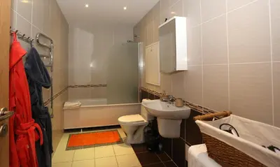 a bathroom with a sink and a toilet and a tub at Apartamentai Panevezys in Panevėžys