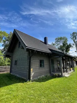 a small house with a roof on a yard at Cozy House by Galuonai Lake - Jauki 3 miegamųjų sodyba 200 m nuo Galuonų ežero in Inturkė