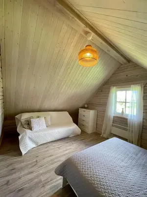a bedroom with two beds in a attic at Cozy House by Galuonai Lake - Jauki 3 miegamųjų sodyba 200 m nuo Galuonų ežero in Inturkė