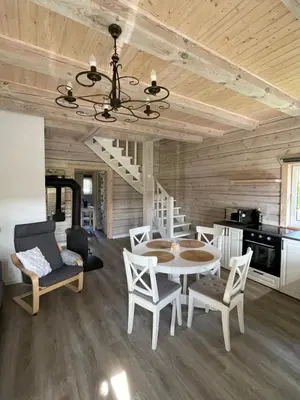 a dining room with a table and chairs at Cozy House by Galuonai Lake - Jauki 3 miegamųjų sodyba 200 m nuo Galuonų ežero in Inturkė