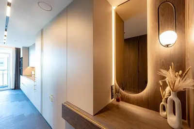 a bathroom with a vanity with a mirror and a vase at Castle Town Kaunas Apartaments in Kaunas