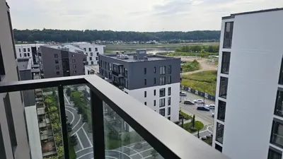an apartment balcony with a view of a city at Castle Town Kaunas Apartaments in Kaunas