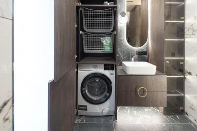 a bathroom with a washing machine and a sink at Castle Town Kaunas Apartaments in Kaunas