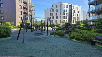 an empty playground in a city with buildings at Castle Town Kaunas Apartaments in Kaunas